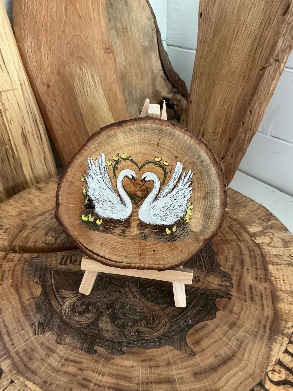 Swans beautifully laser engraved and hand painted onto a slice of oak with stand