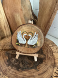 Swans beautifully laser engraved and hand painted onto a slice of oak with stand
