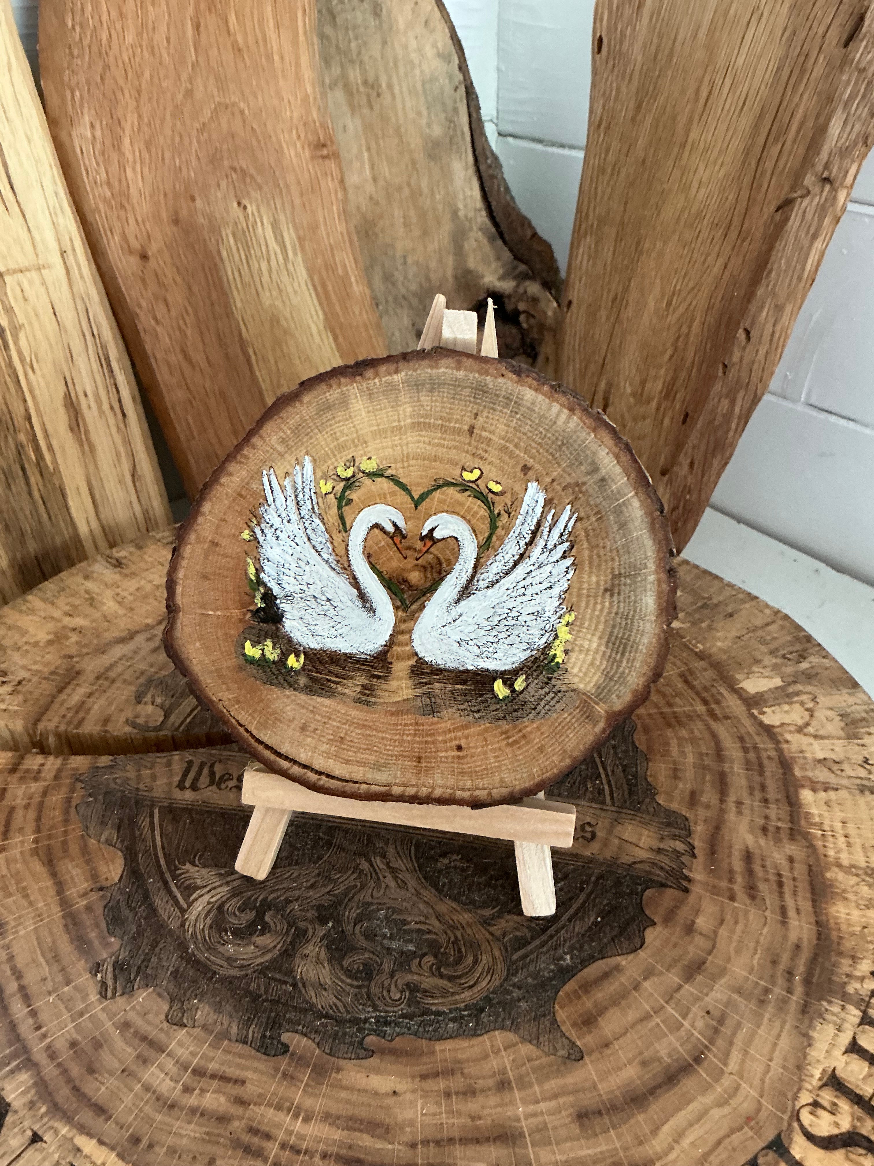 Swans beautifully laser engraved and hand painted onto a slice of oak with stand