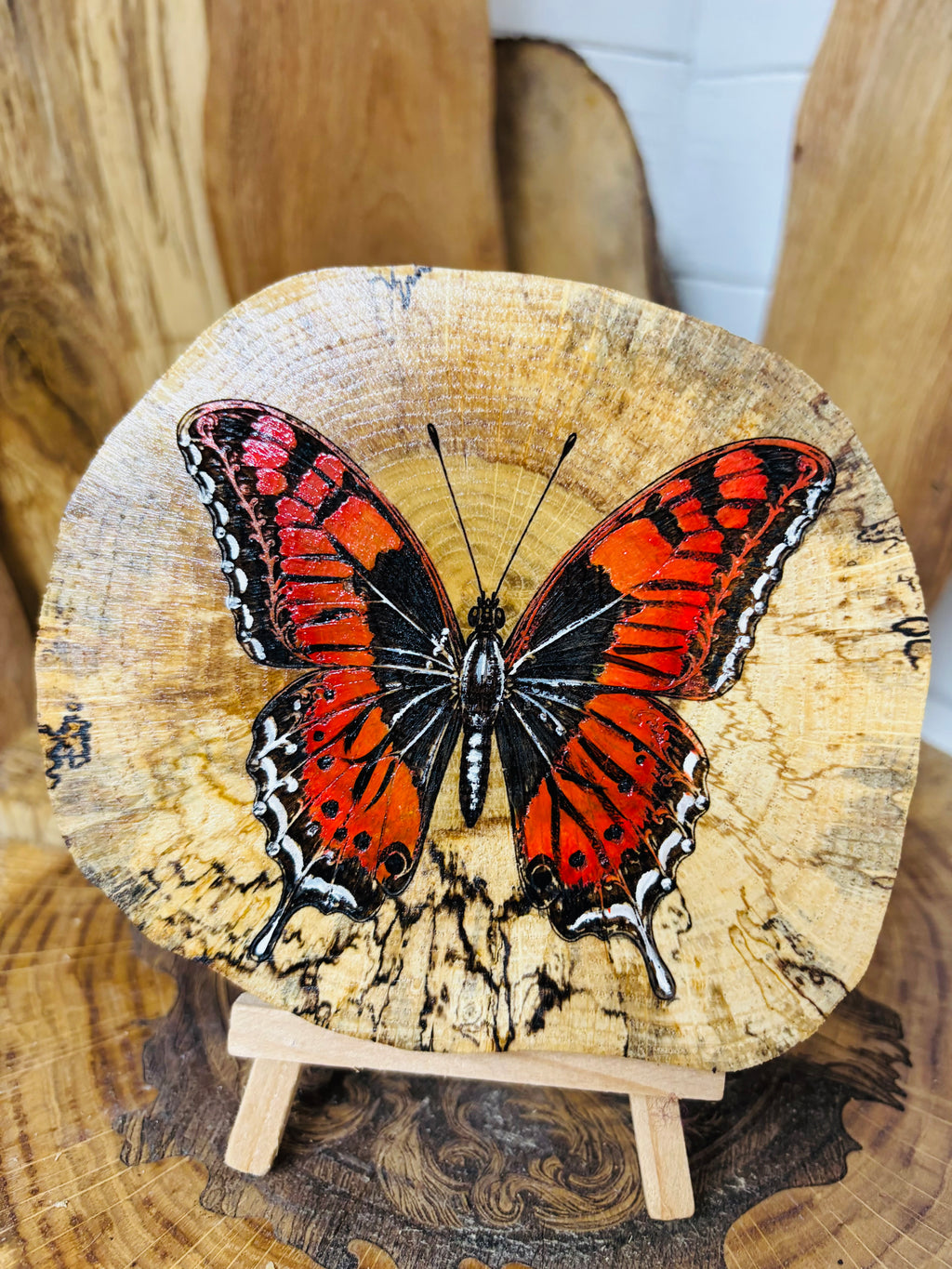 Beautiful butterfly , laser engraved and hand painted onto a slice spalted oak