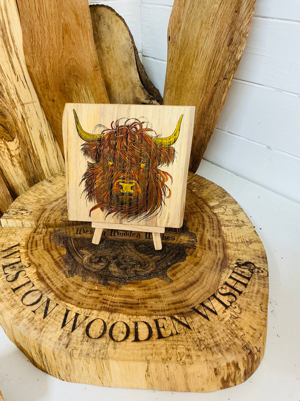 Highland cow laser engraved and hand painted onto a lovely piece of oak with stand