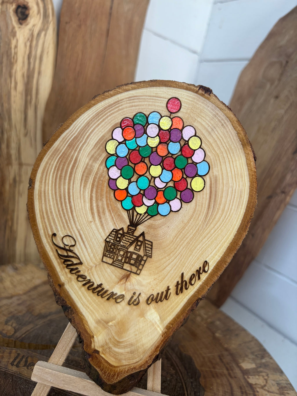 Balloons laser engraved and hand painted onto  very unique balloon shaped logslice with stand