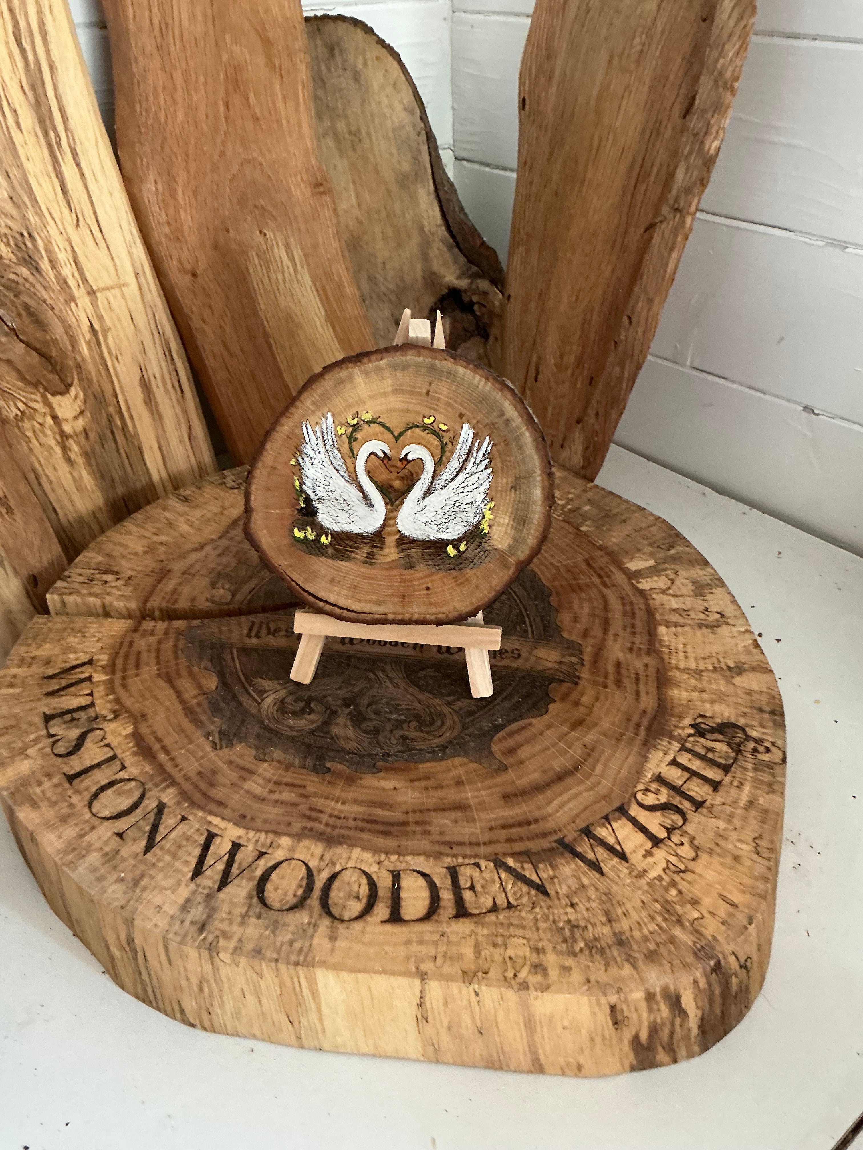 Swans beautifully laser engraved and hand painted onto a slice of oak with stand