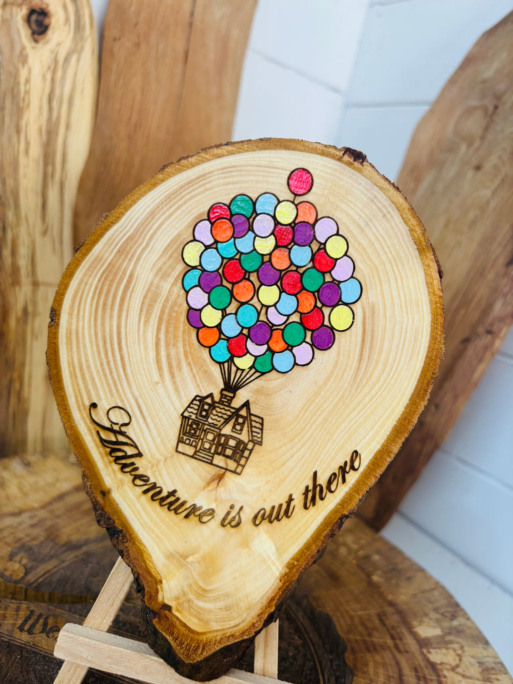 Balloons laser engraved and hand painted onto  very unique balloon shaped logslice with stand