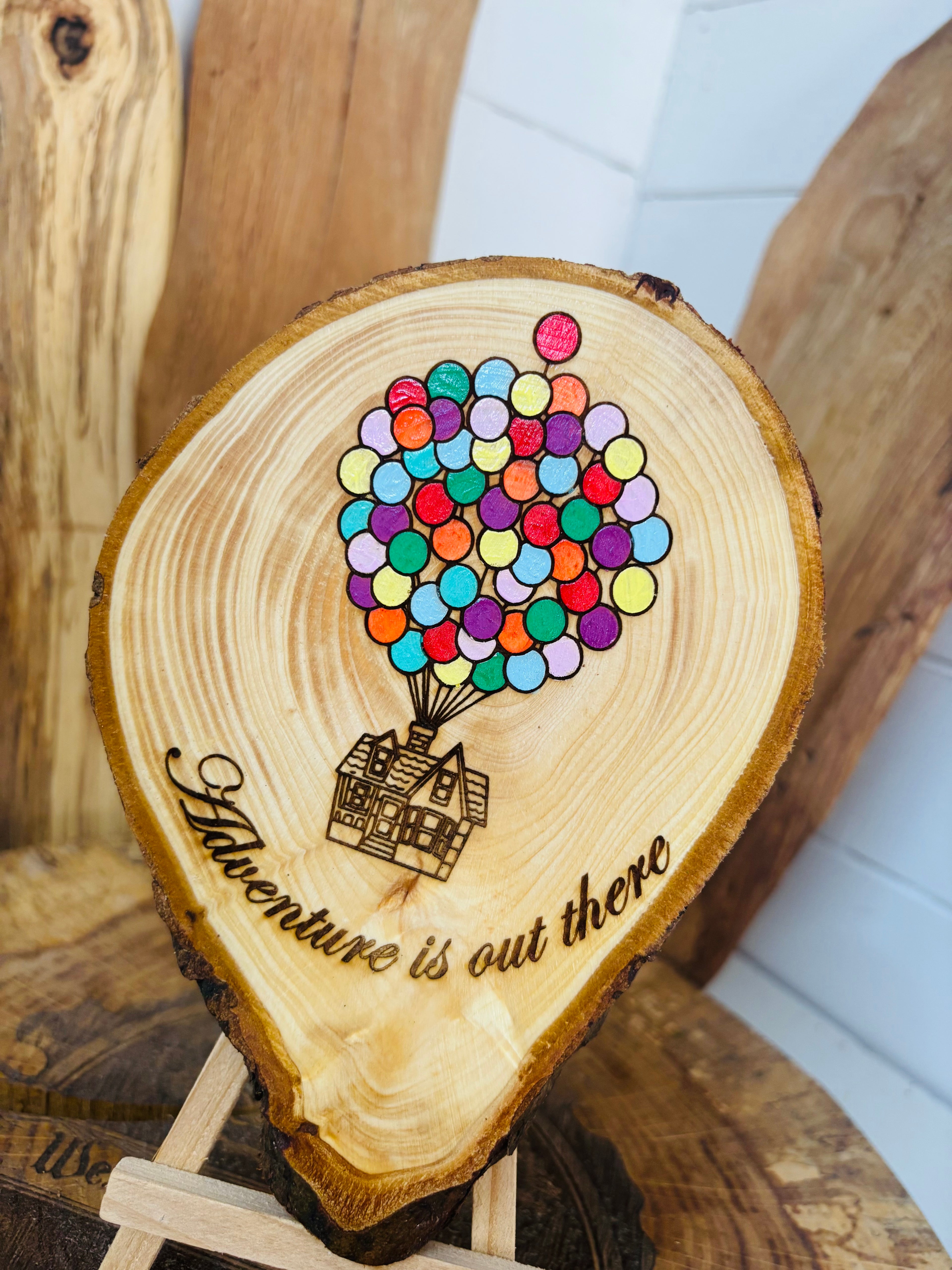 Balloons laser engraved and hand painted onto  very unique balloon shaped logslice with stand