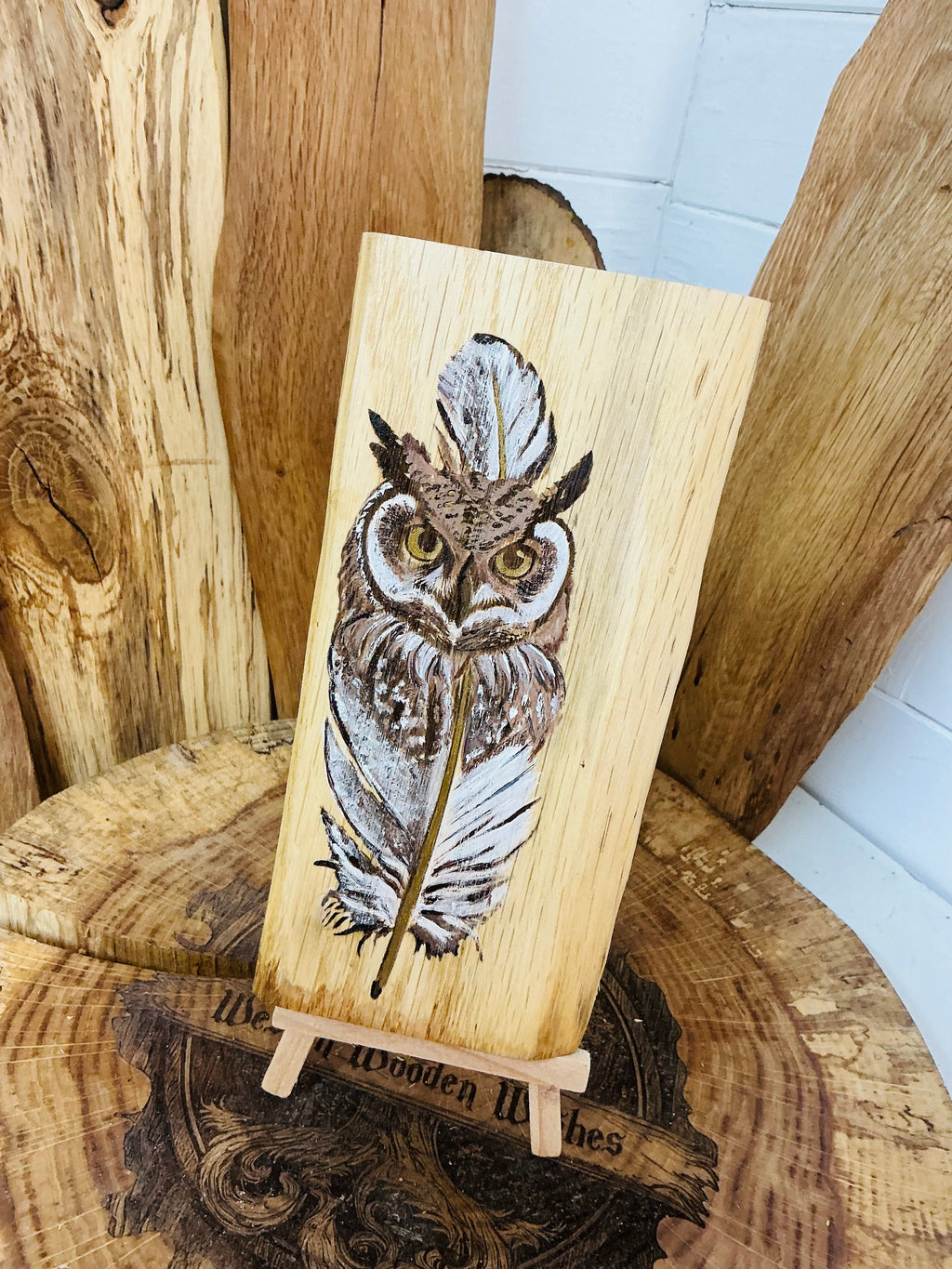 Beautiful owl entwined with a feather laser engraved and hand painted with a touch of metallic gold on an oak plaque with stand
