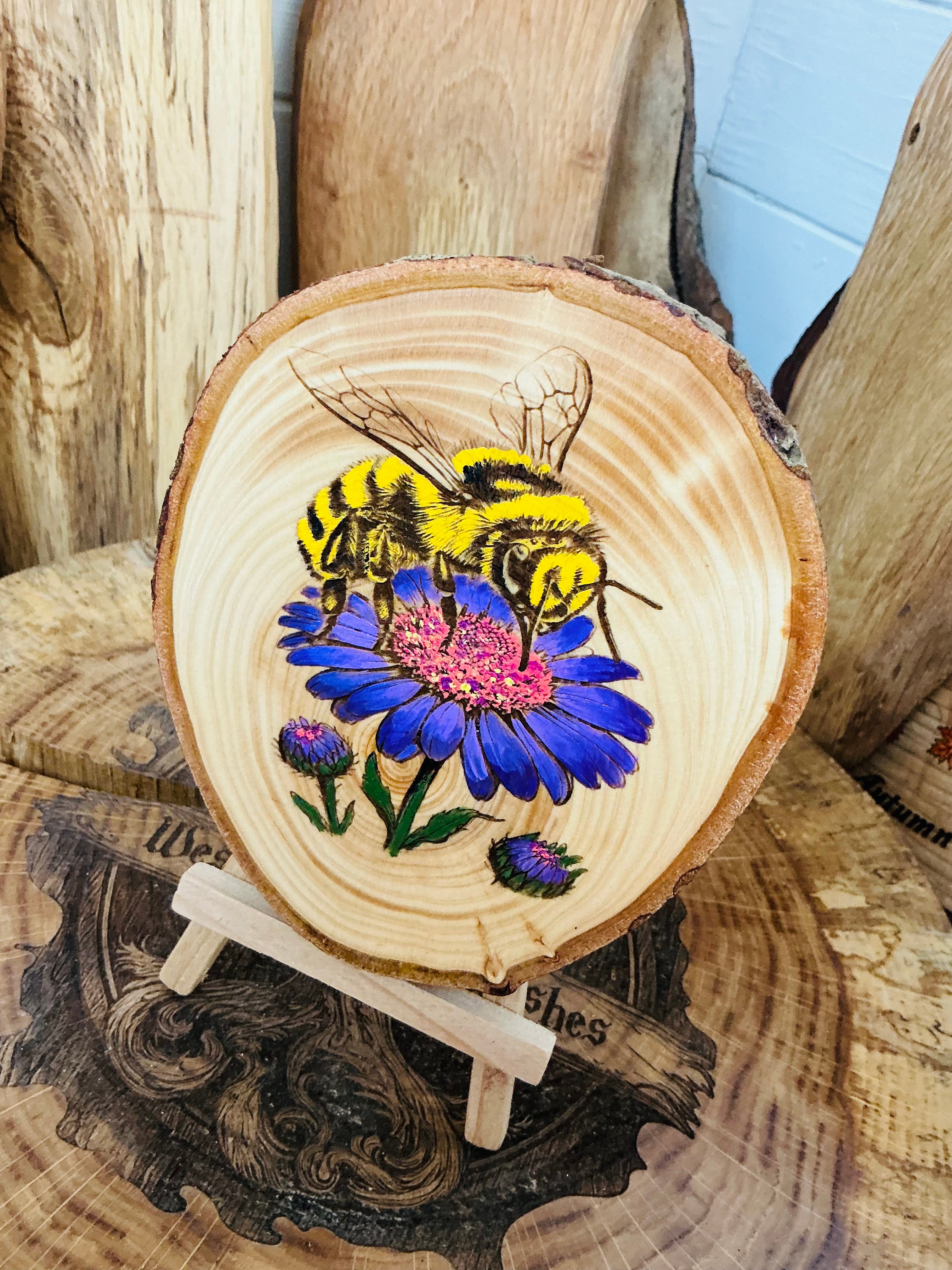 Bee laser engraved and hand painted onto a slice of cedar with stand