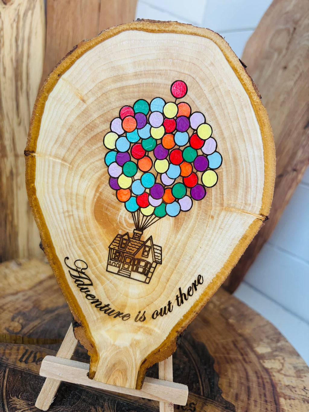 Balloons laser engraved and hand painted onto  very unique balloon shaped logslice with stand