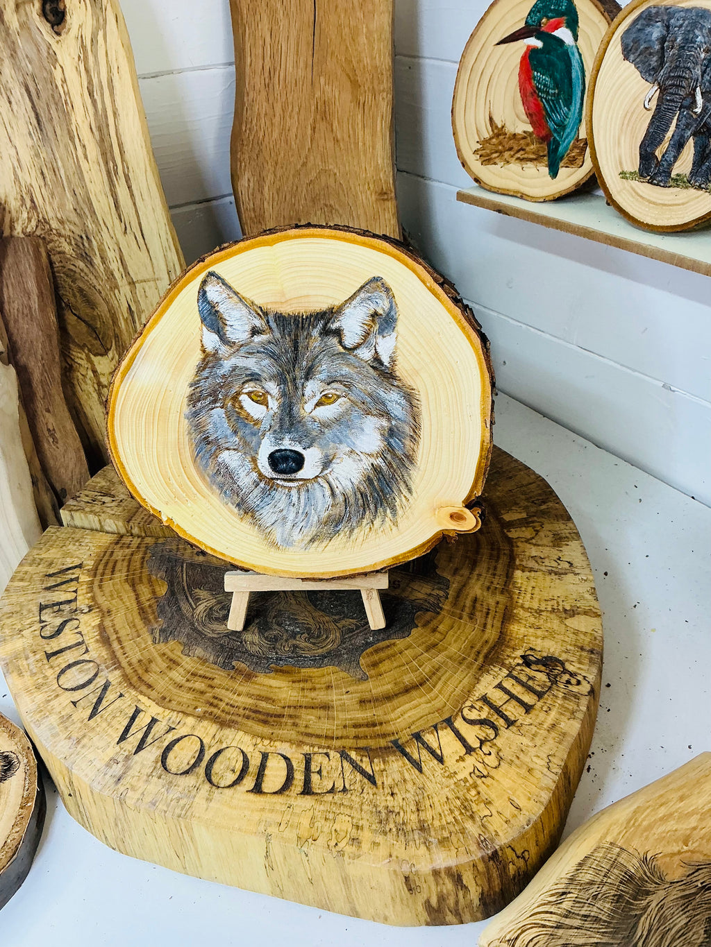 Wolf hand painted onto log slice