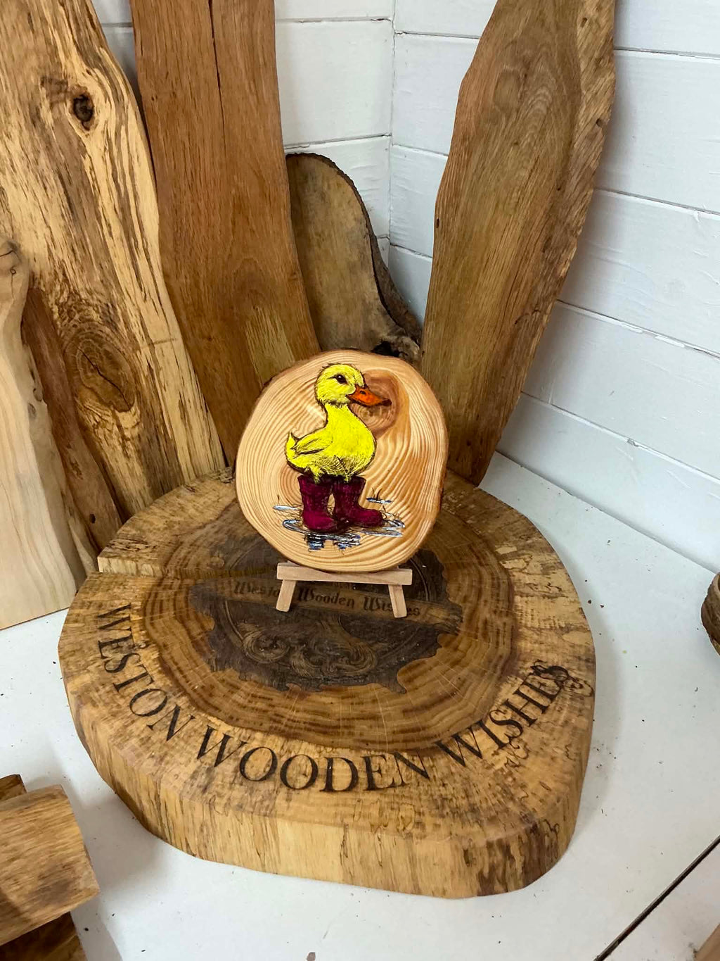 Duck in wellies laser engraved and hand painted onto a log slice with stand