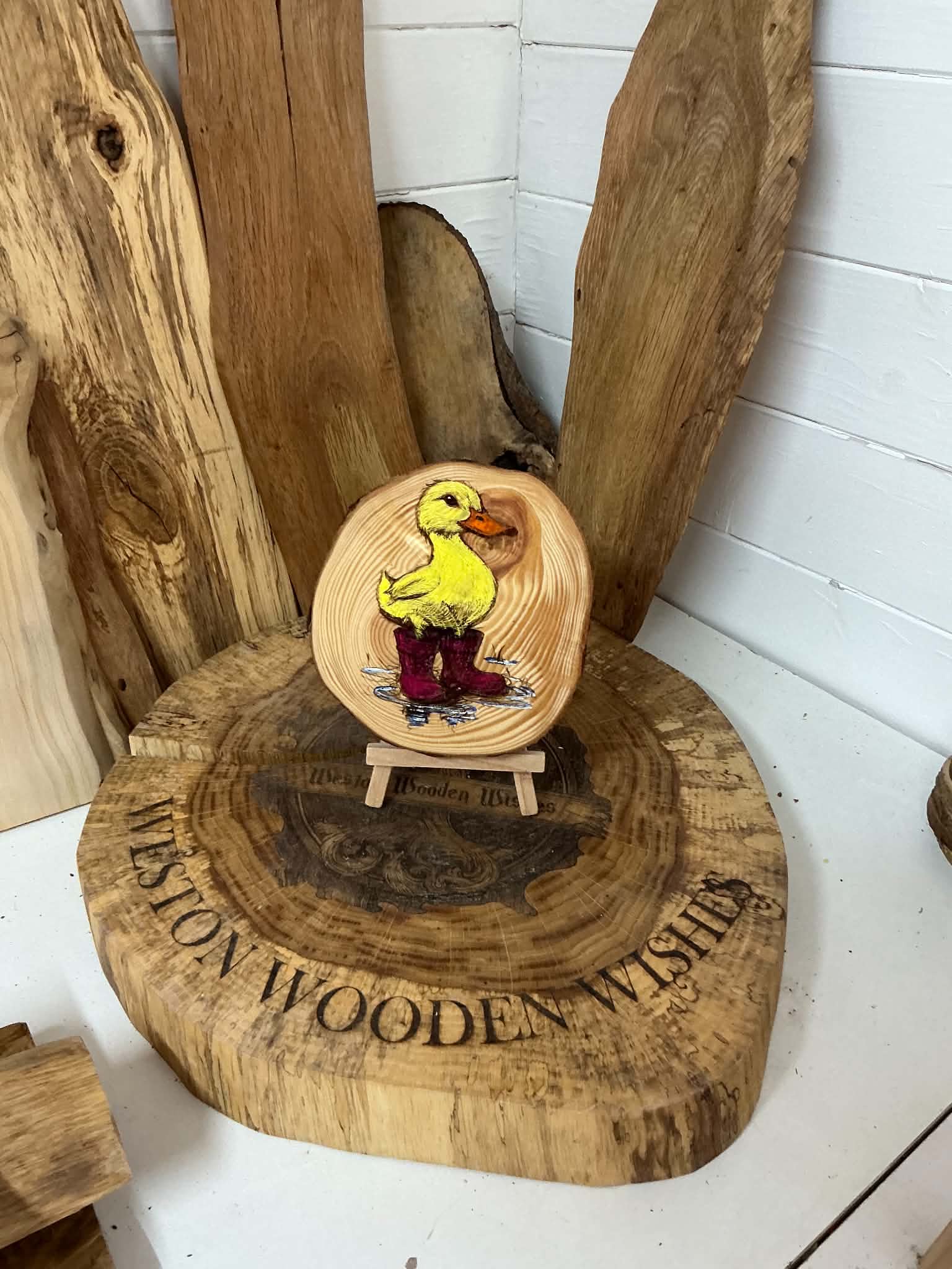 Duck in wellies laser engraved and hand painted onto a log slice with stand