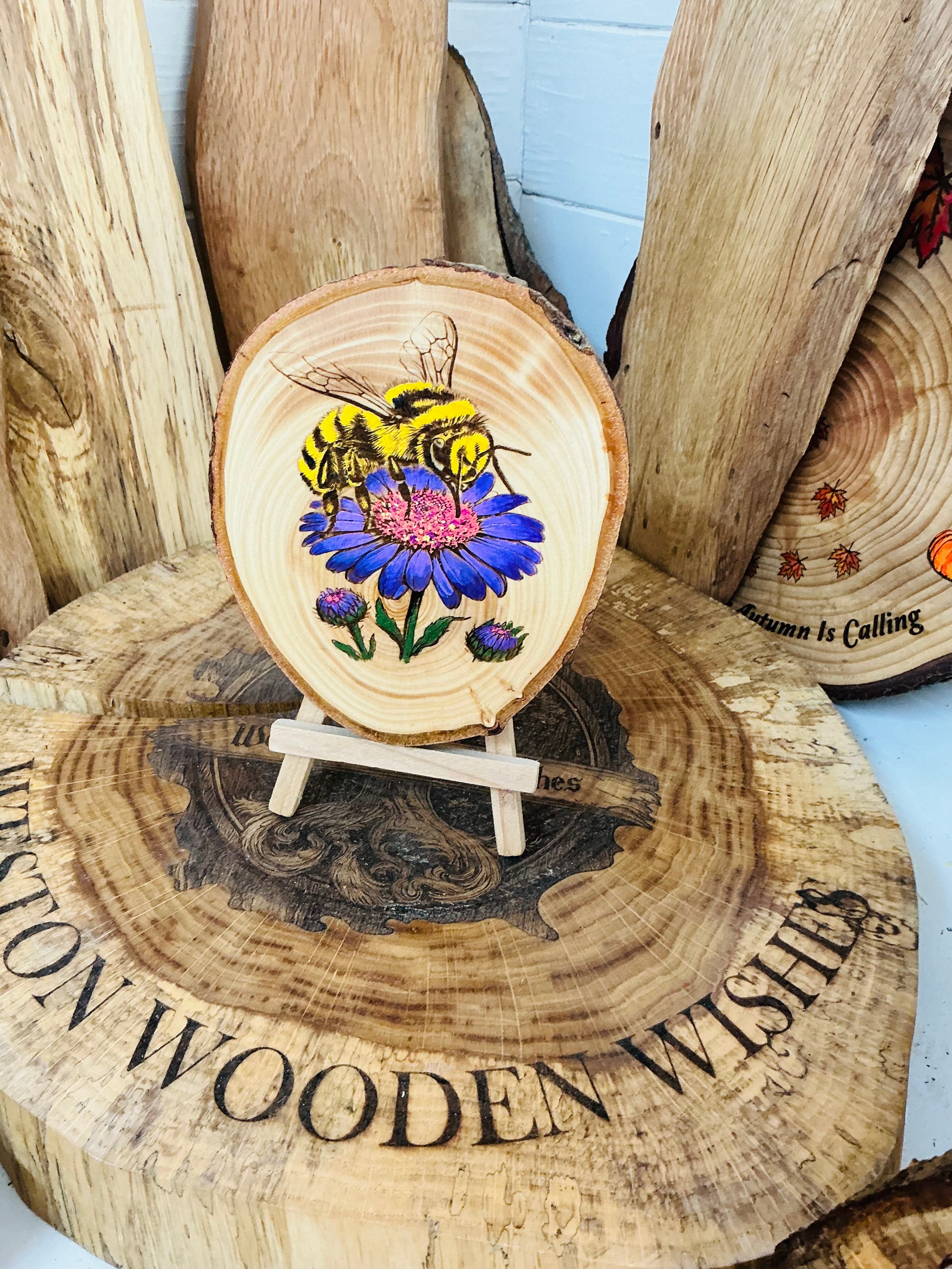 Bee laser engraved and hand painted onto a slice of cedar with stand