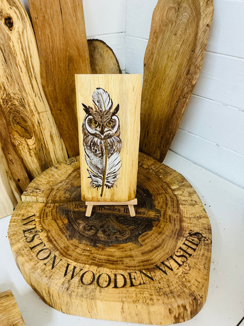 Beautiful owl entwined with a feather laser engraved and hand painted with a touch of metallic gold on an oak plaque with stand
