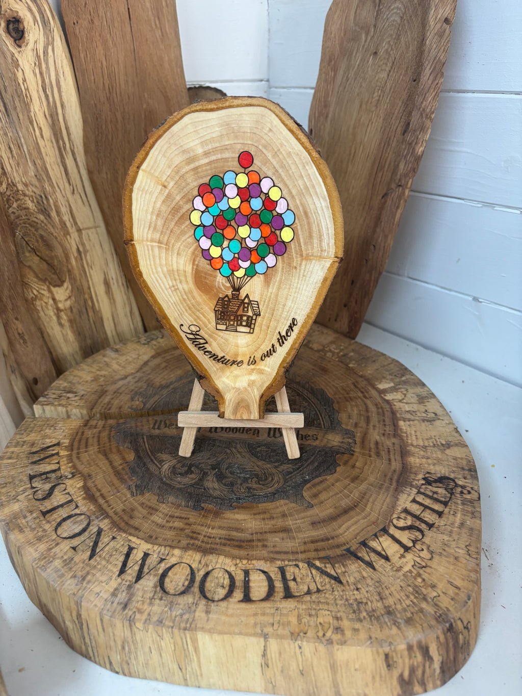 Balloons laser engraved and hand painted onto  very unique balloon shaped logslice with stand