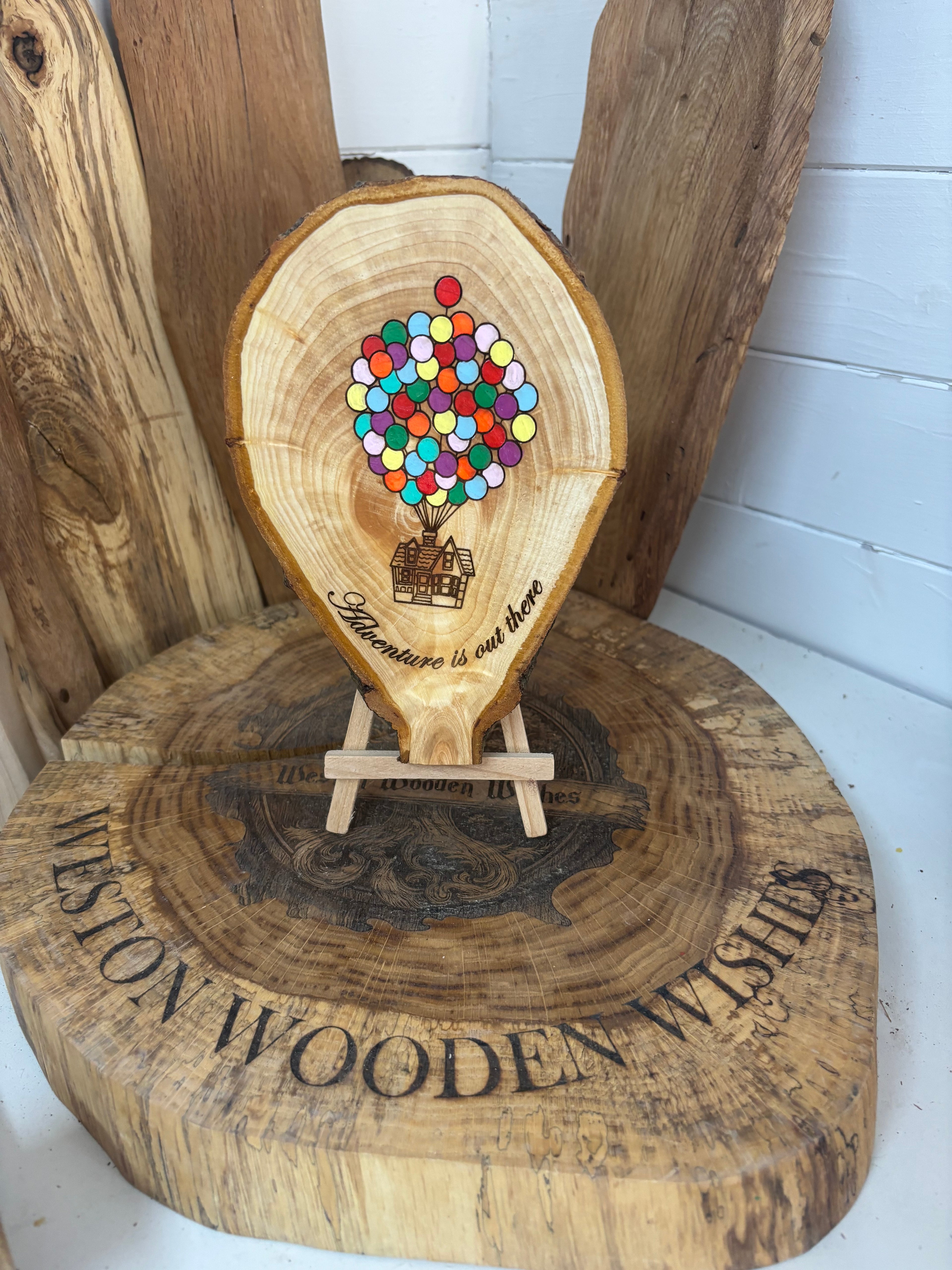 Balloons laser engraved and hand painted onto  very unique balloon shaped logslice with stand