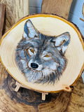 Wolf hand painted onto log slice