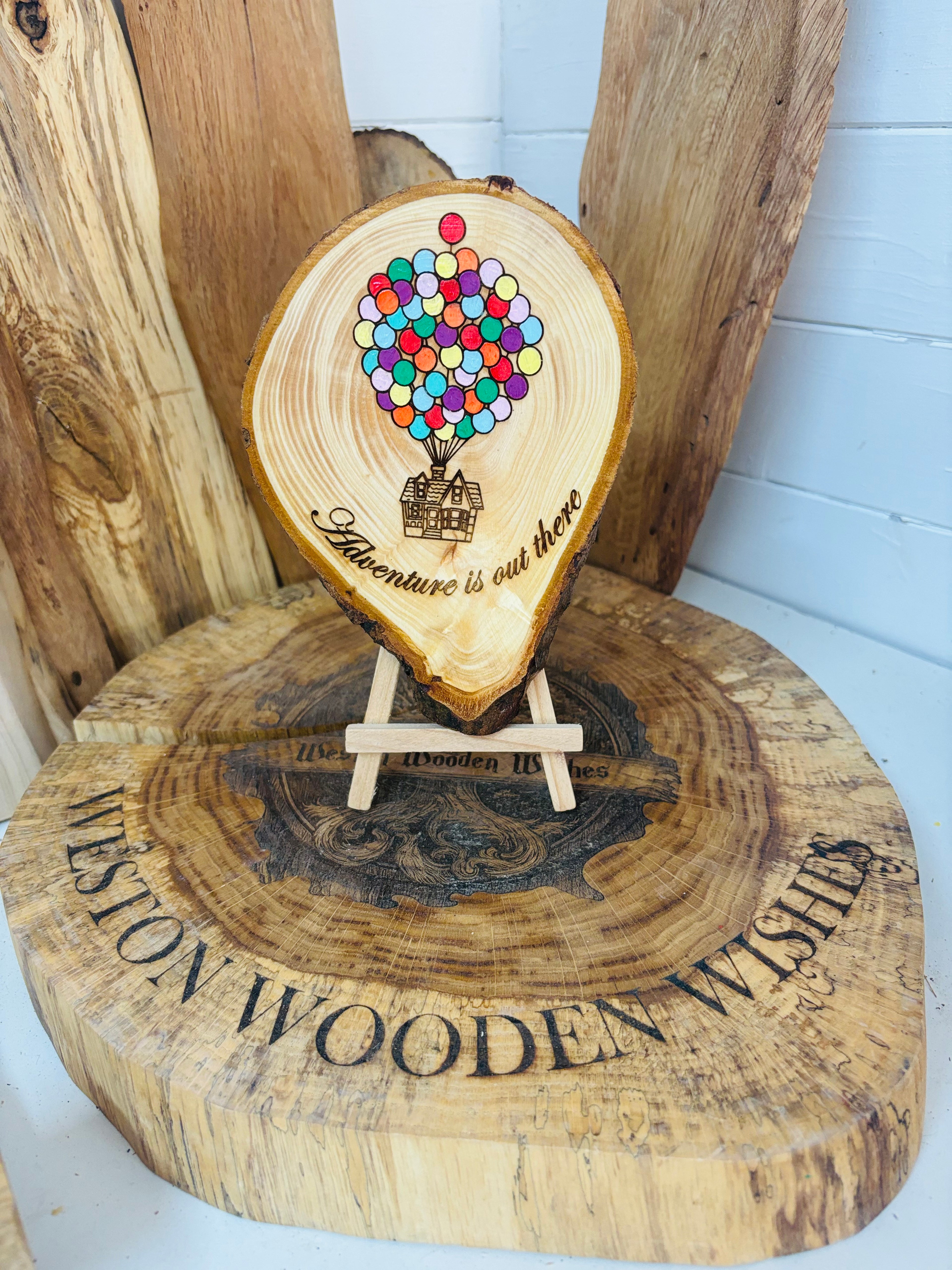 Balloons laser engraved and hand painted onto  very unique balloon shaped logslice with stand