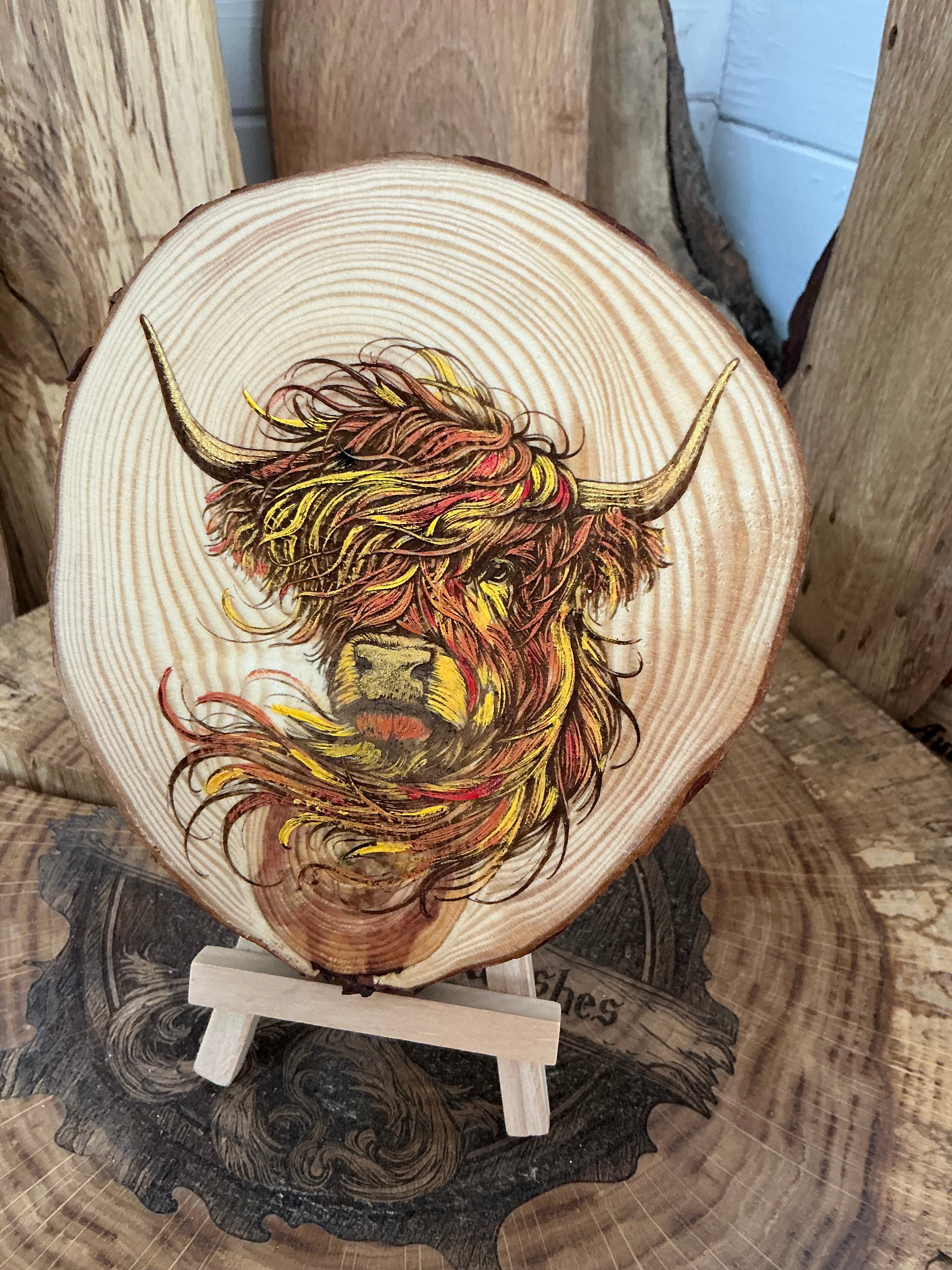 Highland cow laser engraved and hand painted onto a rustic Log slice with stand