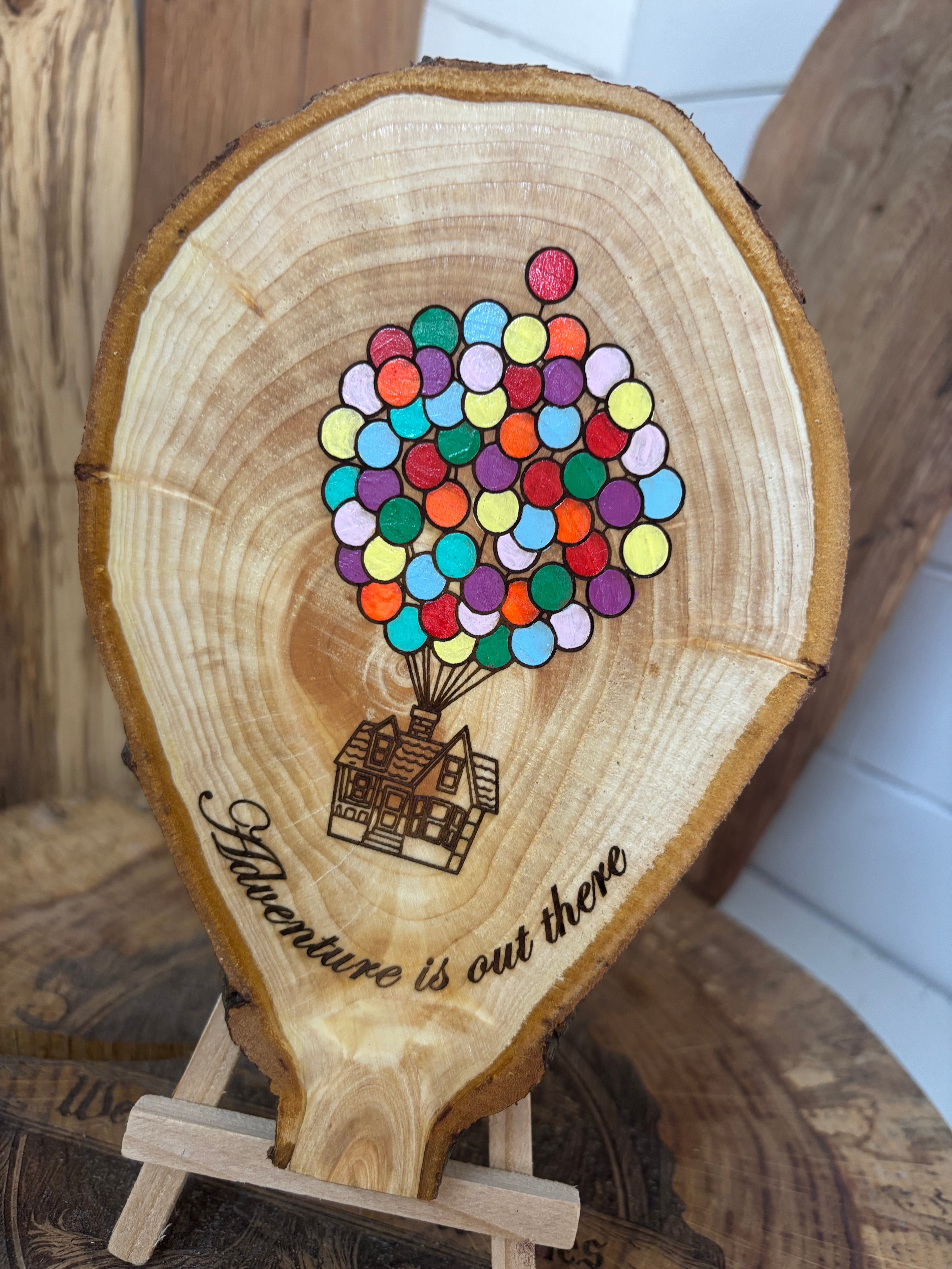 Balloons laser engraved and hand painted onto  very unique balloon shaped logslice with stand