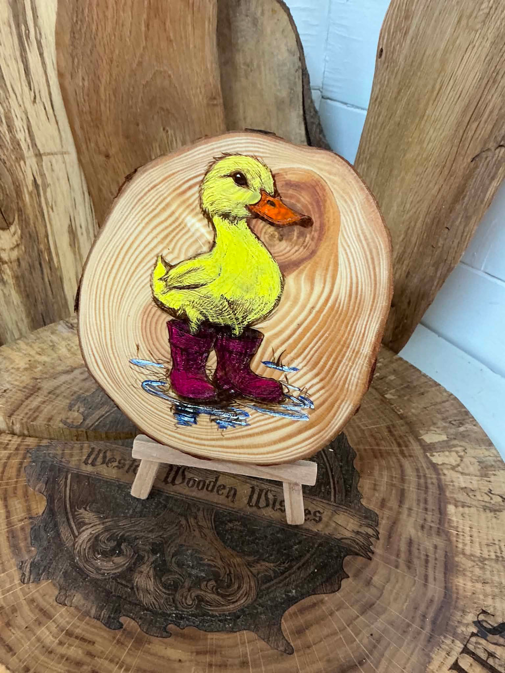 Duck in wellies laser engraved and hand painted onto a log slice with stand
