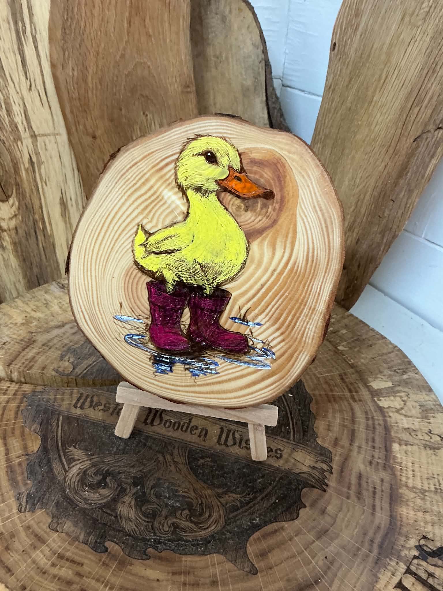 Duck in wellies laser engraved and hand painted onto a log slice with stand